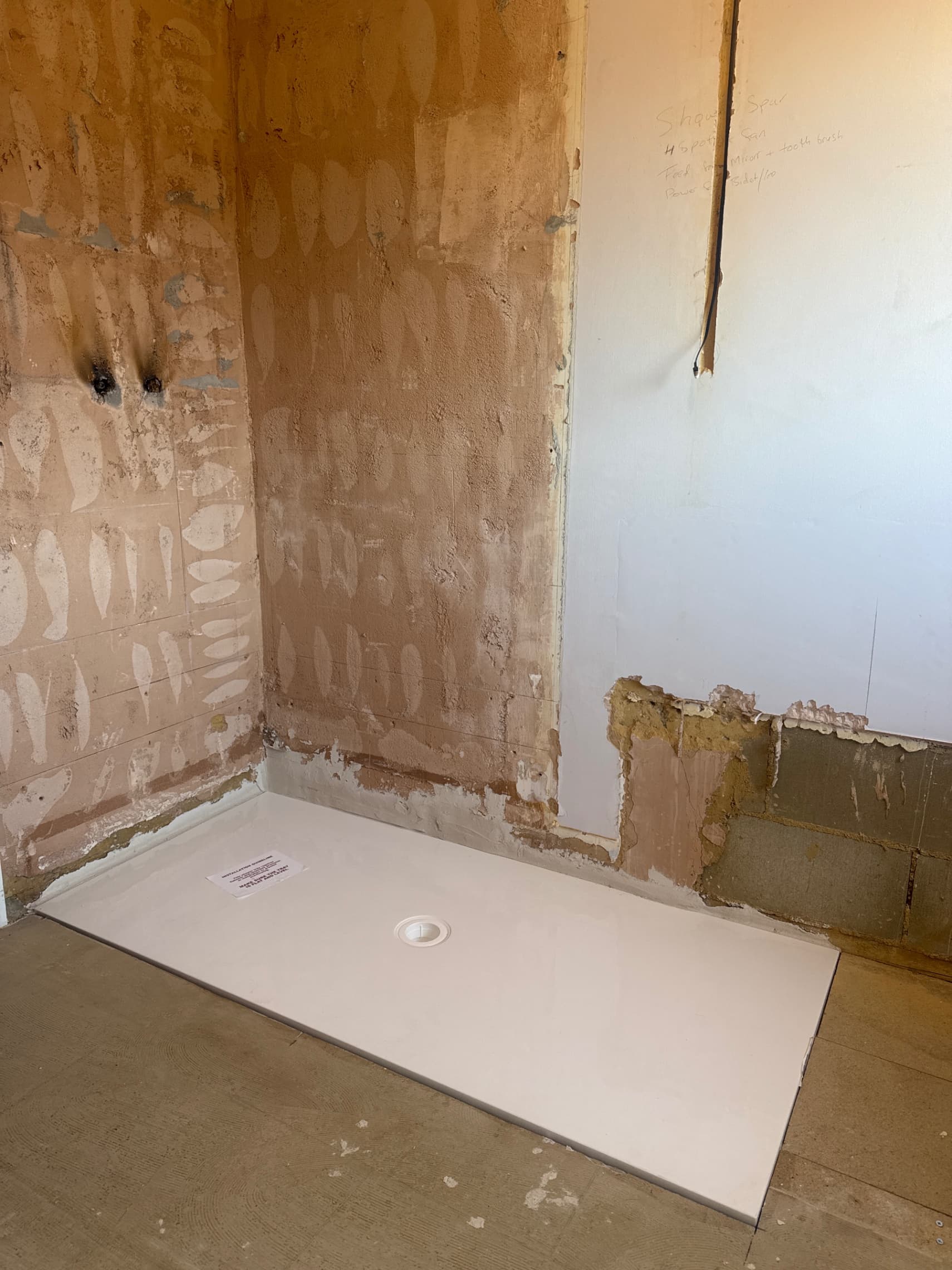 We've stripped out the old bathroom and got the new shower tray bedded in and level, ready for the electricians to come in and finish the light installation.