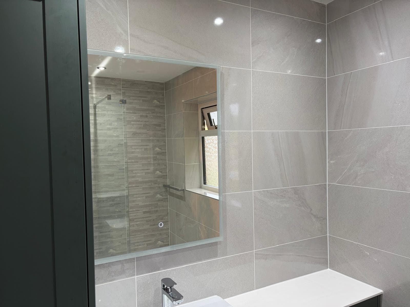 We're just applying the final touches and last up is the lighted mirror behind the sink. That’s a wrap of this bathroom refurb!
